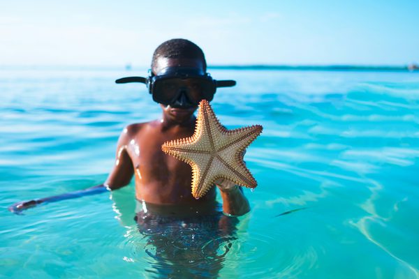 Child with starfish Caye Caulker Belize