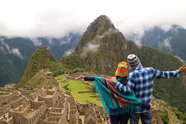 Couple admiring the spectacular view of Machu Picchu Canva Pro