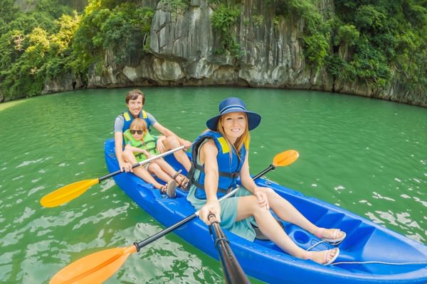 Family canoeing in Ha Long Bay Vietnam